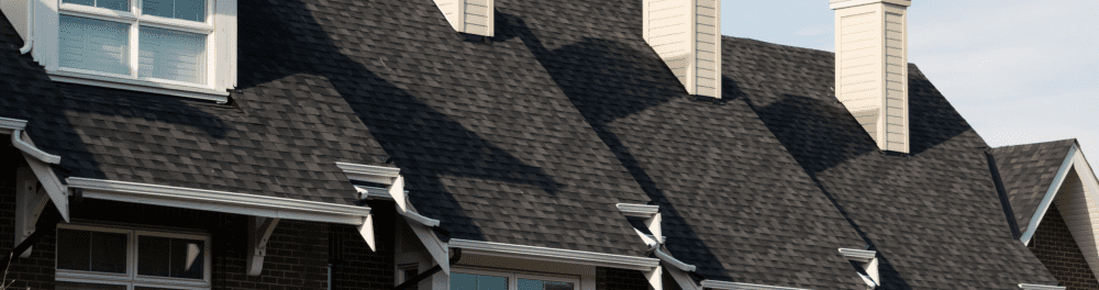 Newly installed shingles on a multi-family property roof in the Richmond area.