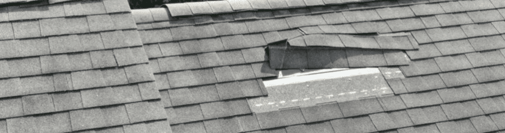 A close up image of damaged shingles.