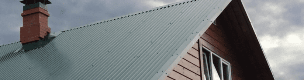 A metal roof stands strong against the elements. In the background on dark, threatening clouds.