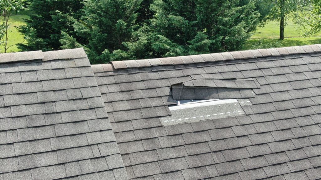 Shingles torn off roof by hurricane