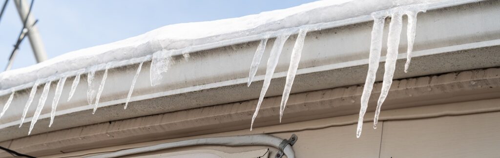 Ice dams forming on roof of business in the short-term after snowfall