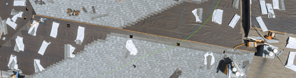 Roofing inspection drone shot of asphalt shingle installation in progress.